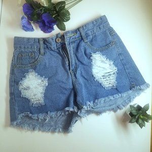 SEXI VINTAGE BLUE SHORTS, WITH RIPPED HOLES IN THE FRONT.